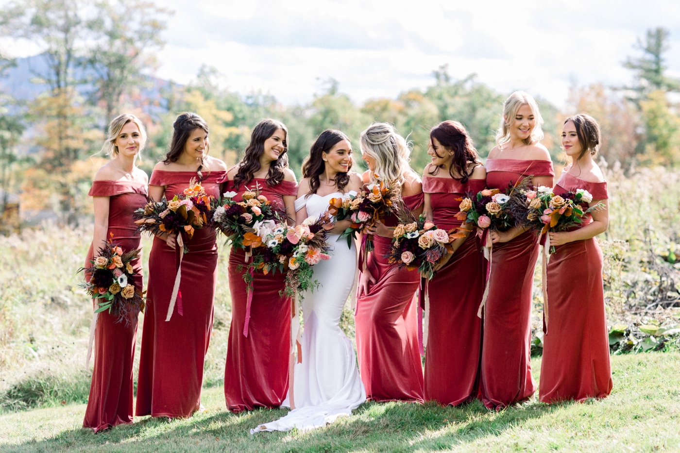 Bridesmaids in velvet rust colored gowns