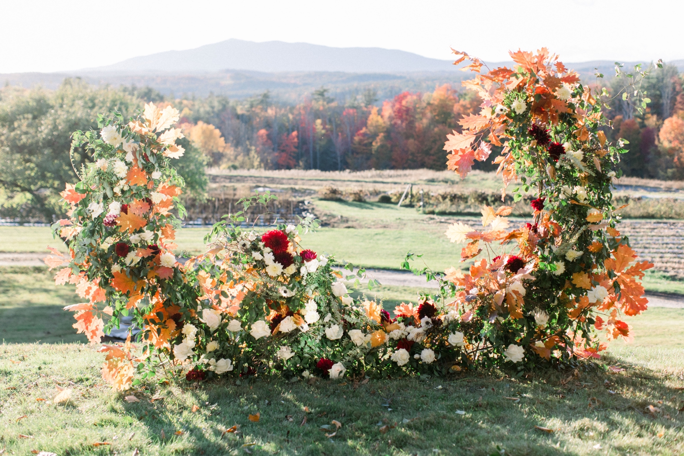 Fall wedding ceremony in New Hampshire with lush flowers