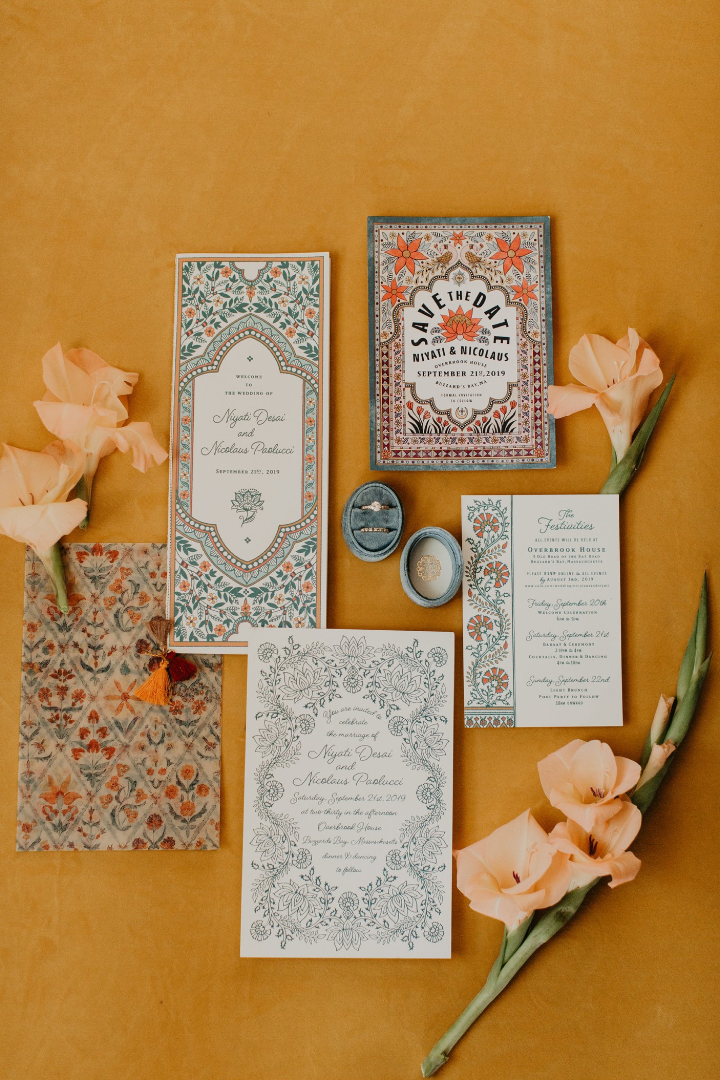 Indian wedding invitation suite with blue vines and orange flowers