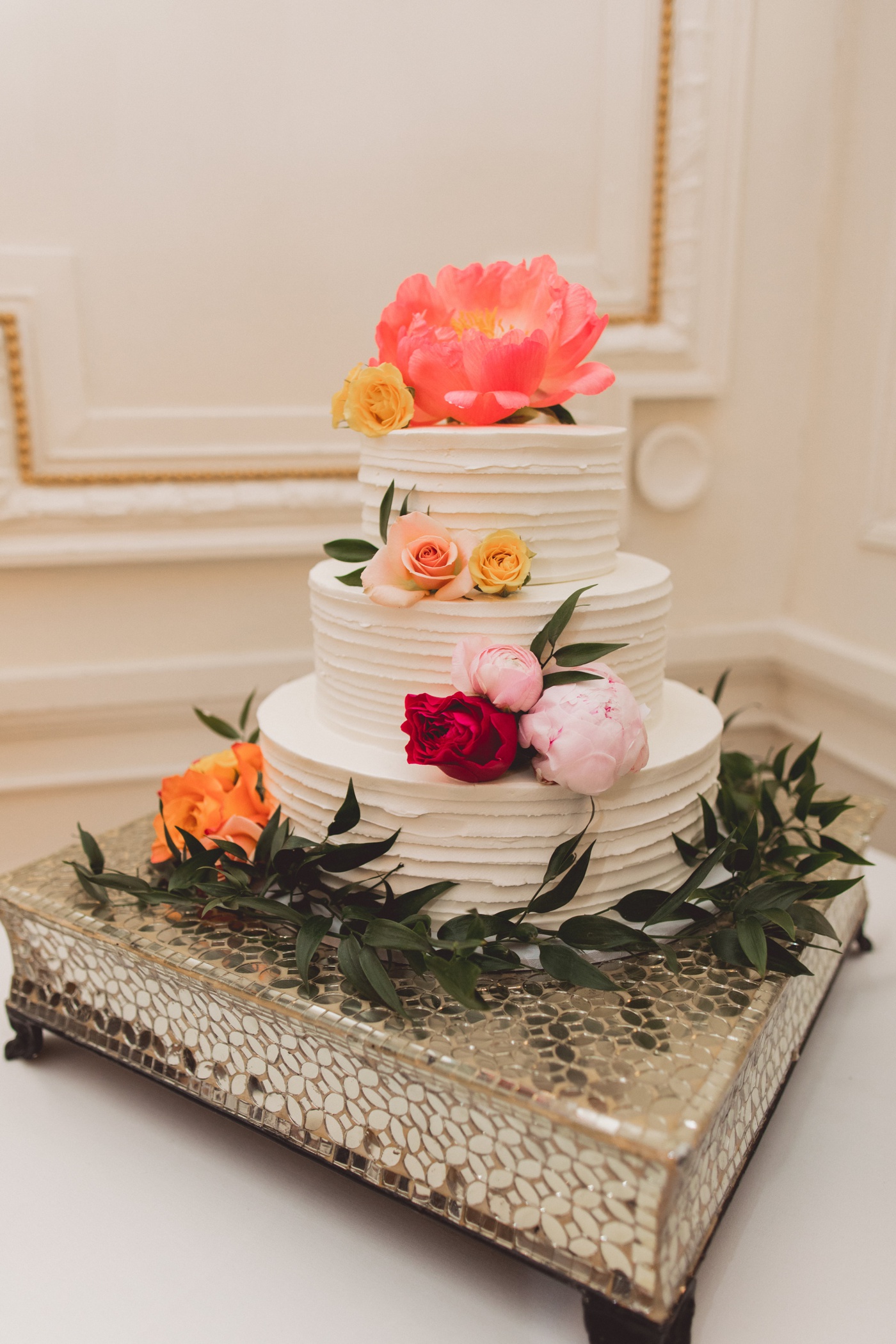 Ribbed buttercream wedding cake with peonies and roses